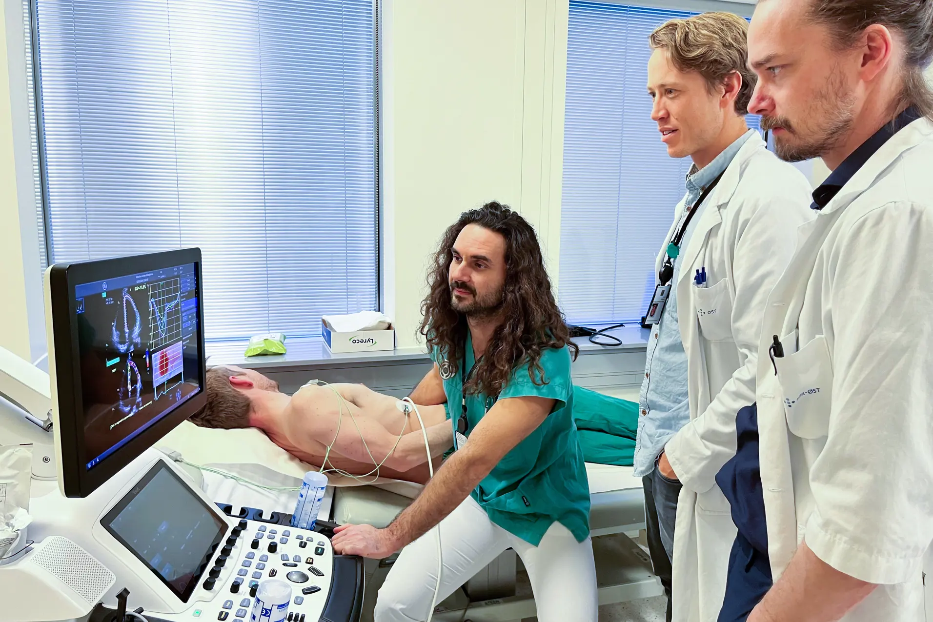Three doctors and a patient at an ecco machine